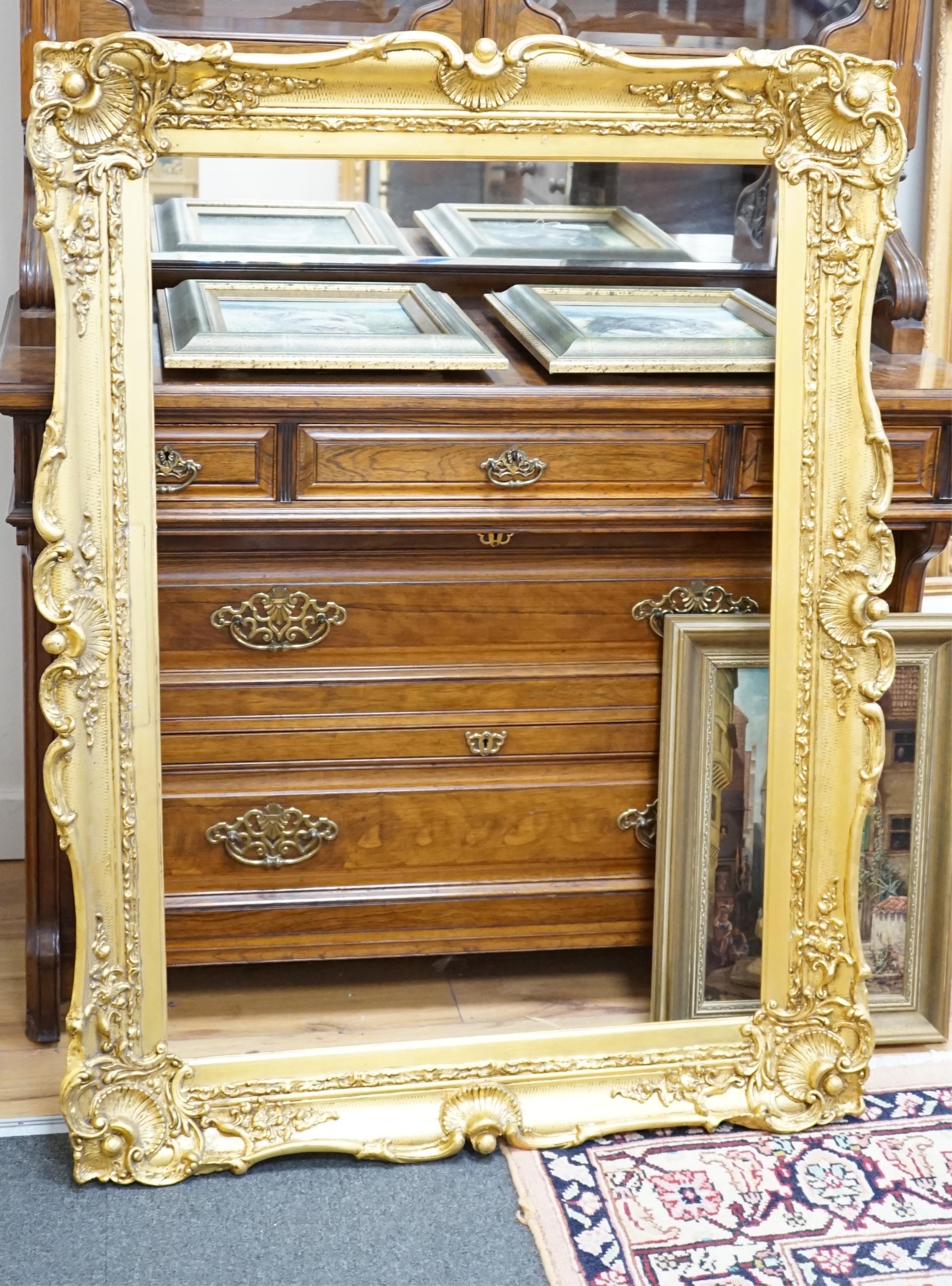 A large Victorian ornate gilt picture frame, aperture size 92 x 64cm. Condition - fair